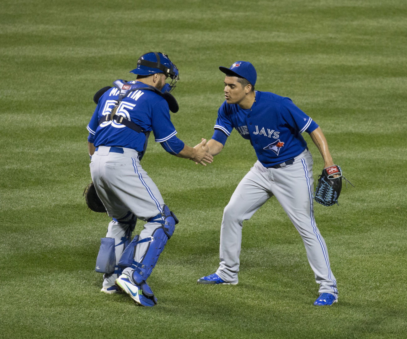 Roberto Osuna celebrates his 20th save of the season with Russell Martin